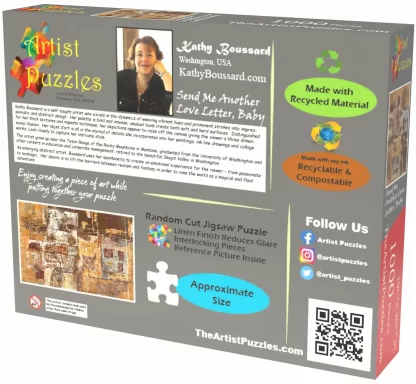 Box back of Artist Puzzles Send Me Another Love Letter, Baby jigsaw puzzle. A picture of and bio info about the artist – Kathy Boussard, a small pic of the puzzle, a pic of a puzzle piece showing the actual size of the pieces, social media links, and a QR code.